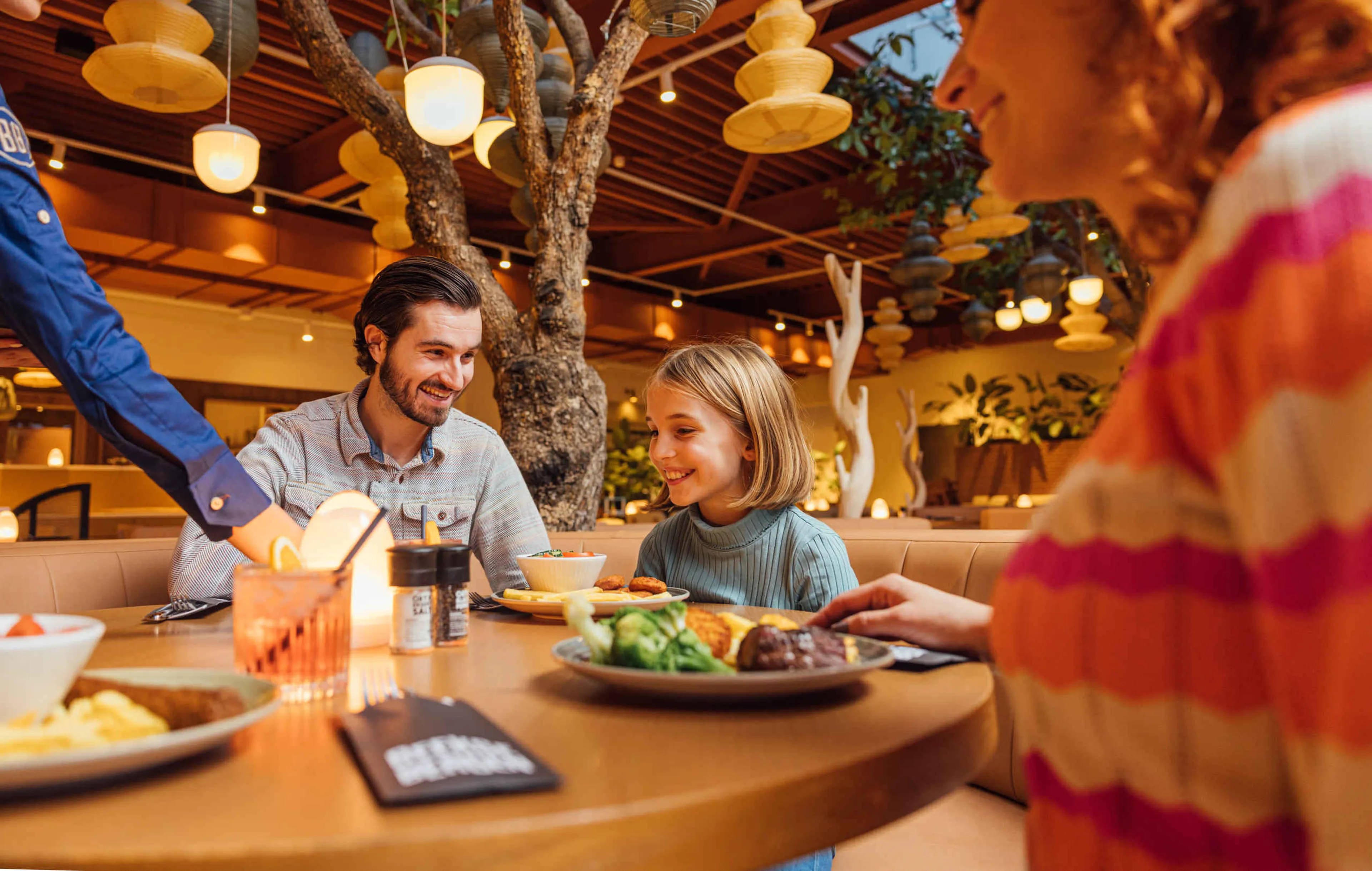 Een gezin zit te dineren bij buffet en live cooking restaurant Amma in Safari Hotel Beekse Bergen.