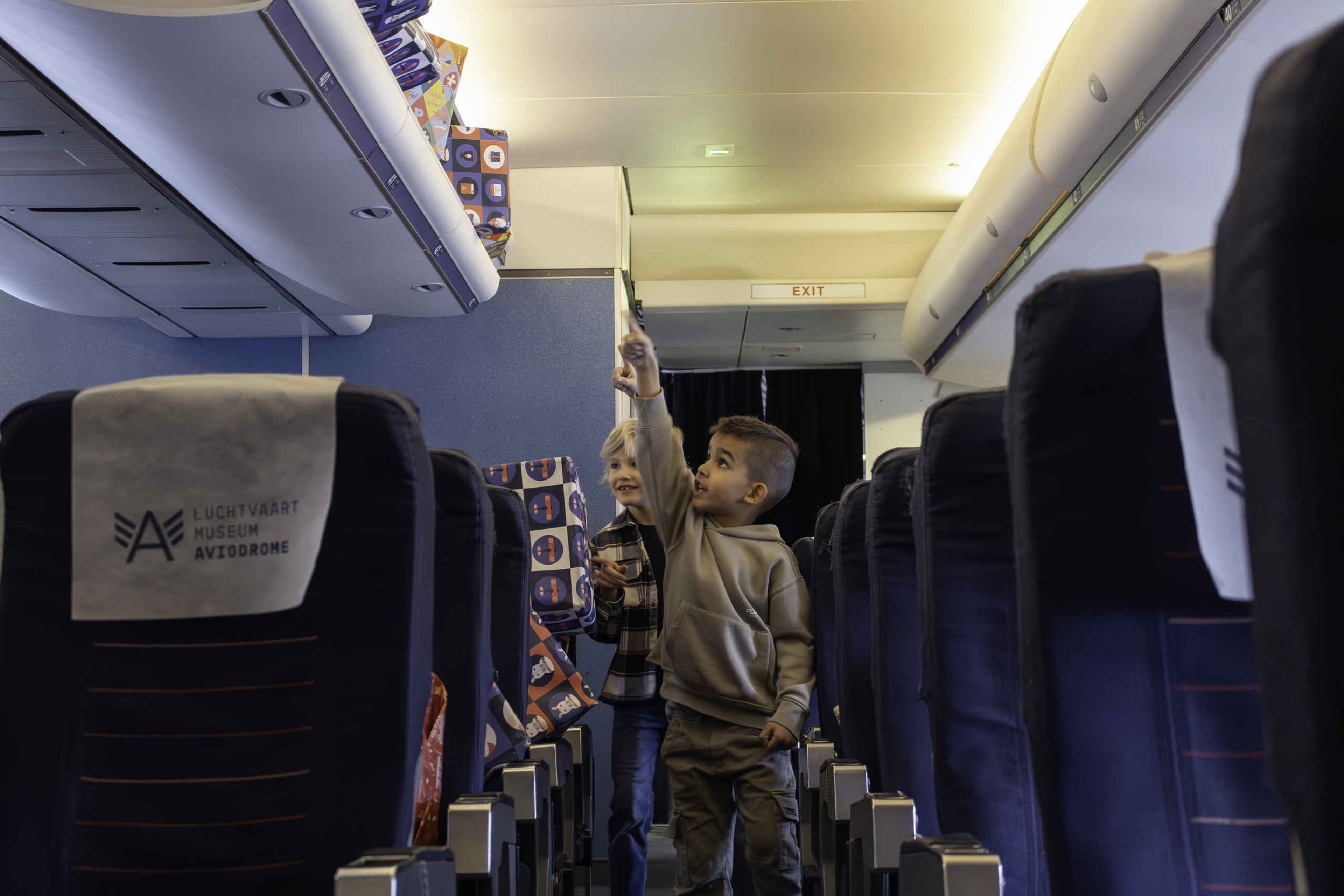 Kinderen zoeken pakjes in de cabine tijdens SintAIRklaas bij Aviodrome