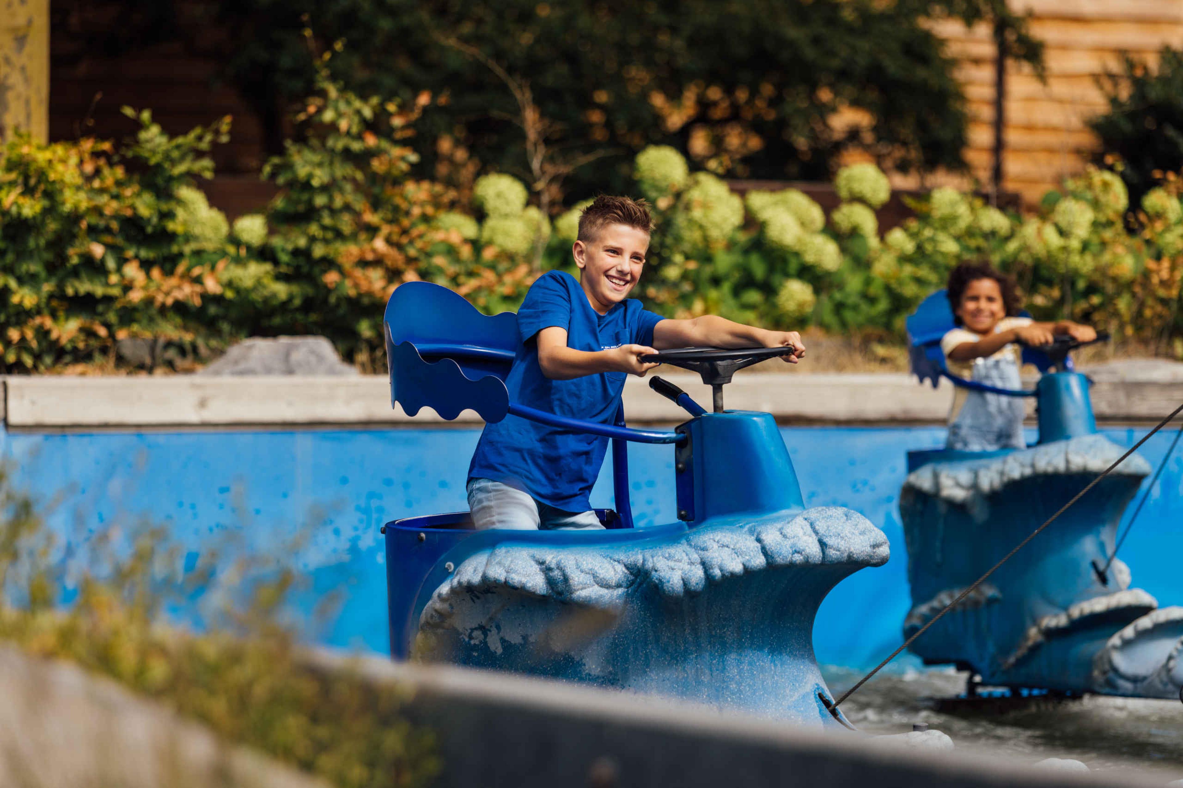 Kinderen op de wave rider attractie bij Speelland Outdoor Beekse Bergen