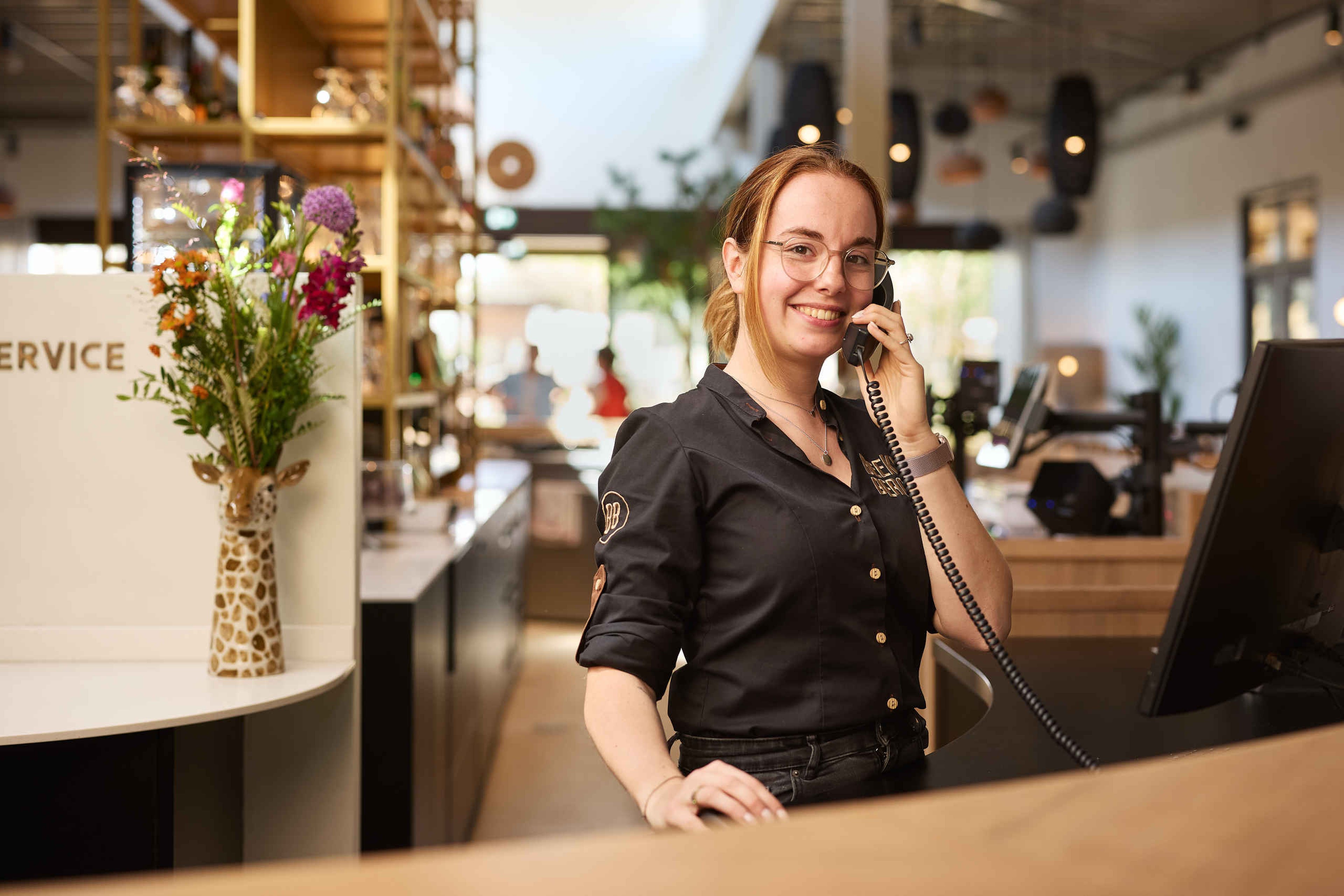 Medewerker Gastenservice aan de telefoon in Safari Hotel Beekse Bergen