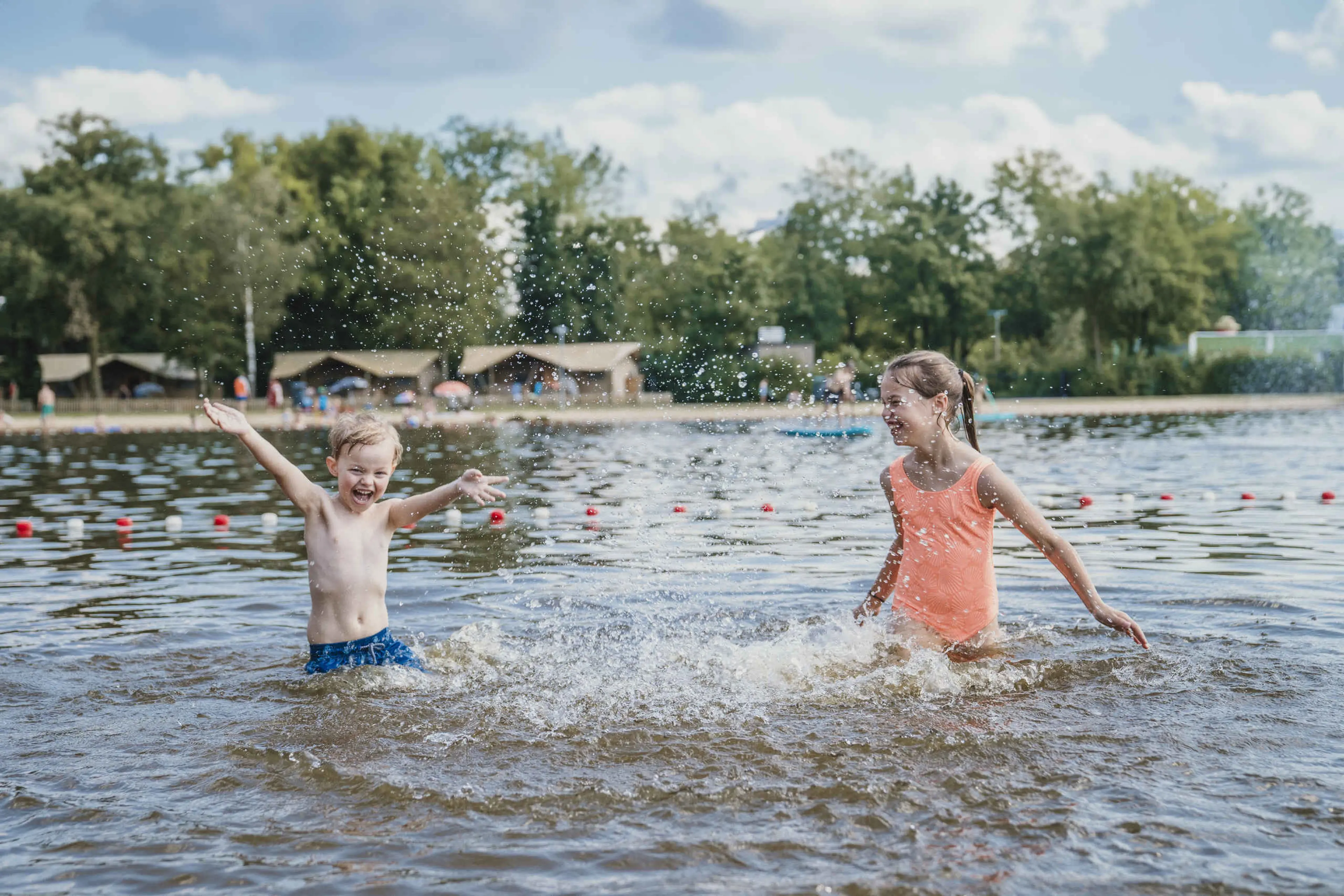Een jongen en een meisje spelen in de zwemvijver bij Vakantiepark Dierenbos
