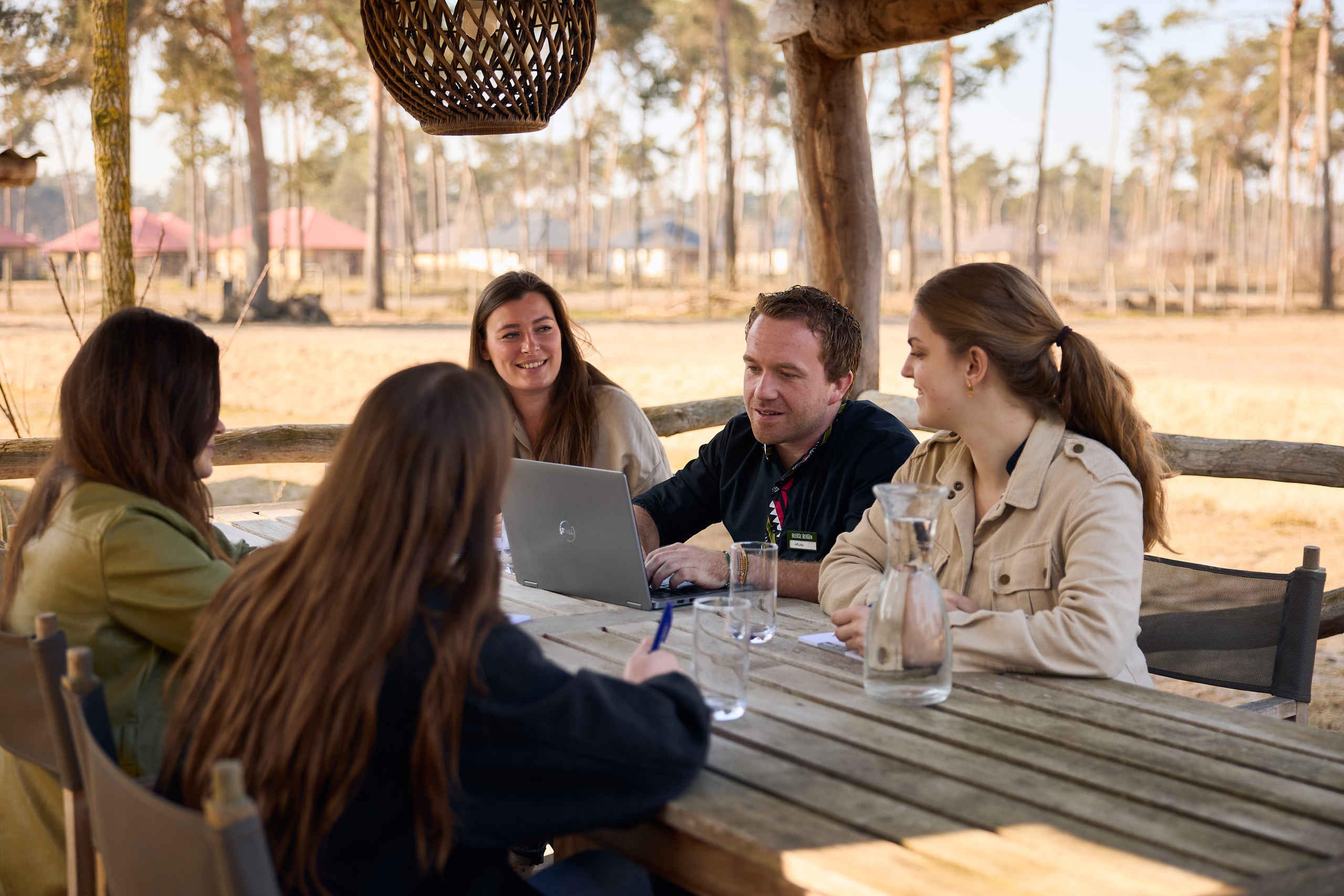 Een groep collega's tijdens een vergadering op het terras van het Safari Resort Beekse Bergen