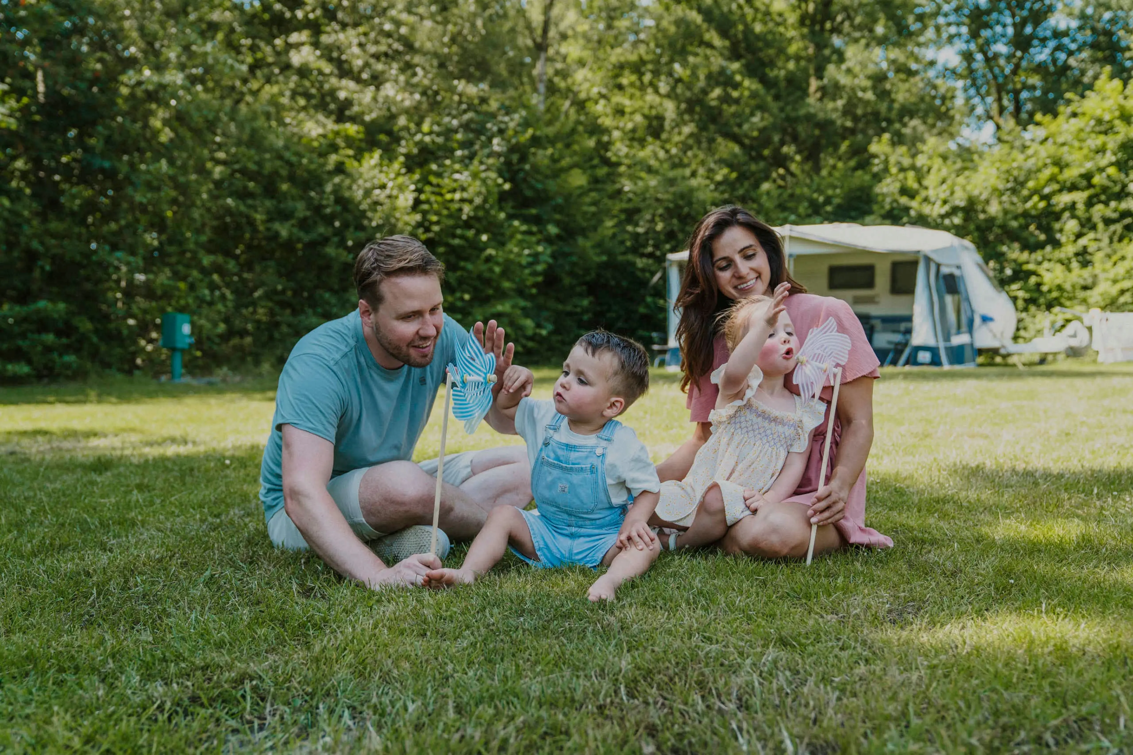 Een gezin speelt met z'n allen op het grasveld van de camping bij Vakantiepark Dierenbos.