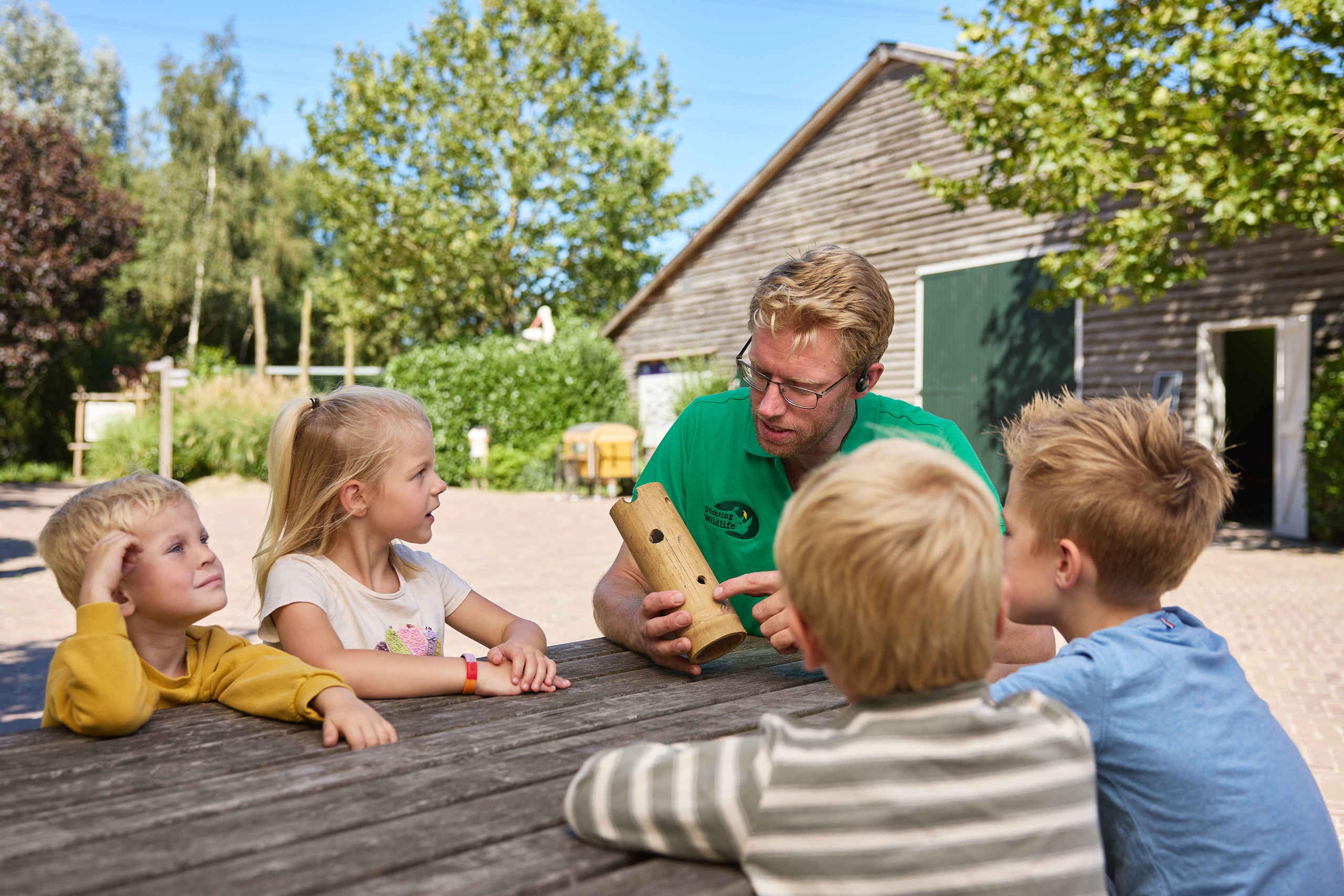 Vrijwilliger geeft kinderen uitleg in ZooParc Overloon