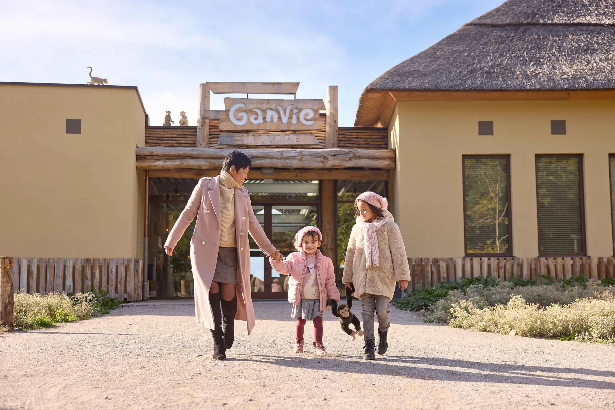 Een vrouw en haar kinderen lopen bij Ganvie Village op Lake Resort Beekse Bergen.