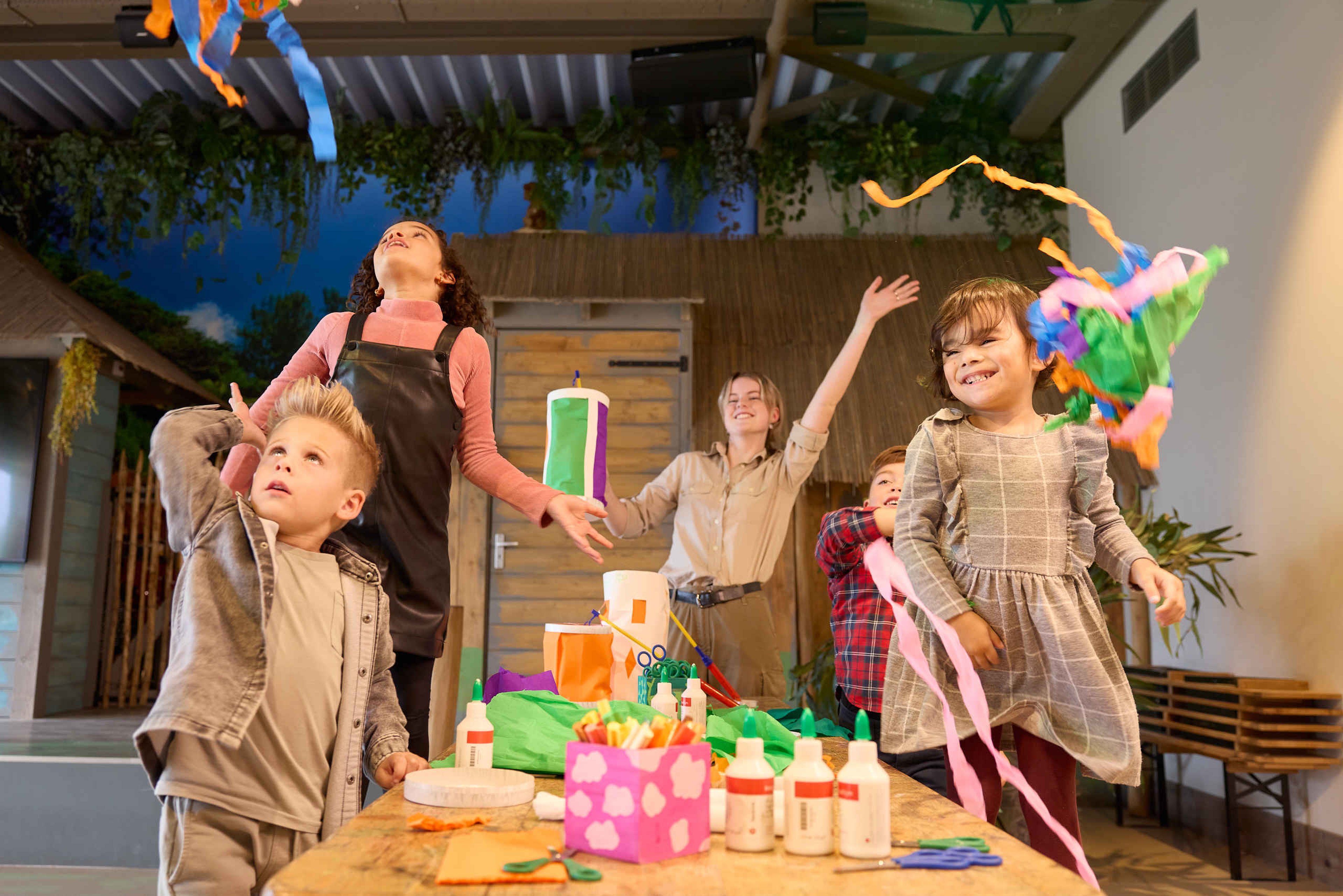 Animatie medewerker en kinderen aan het knutselen in Beekse Bergen