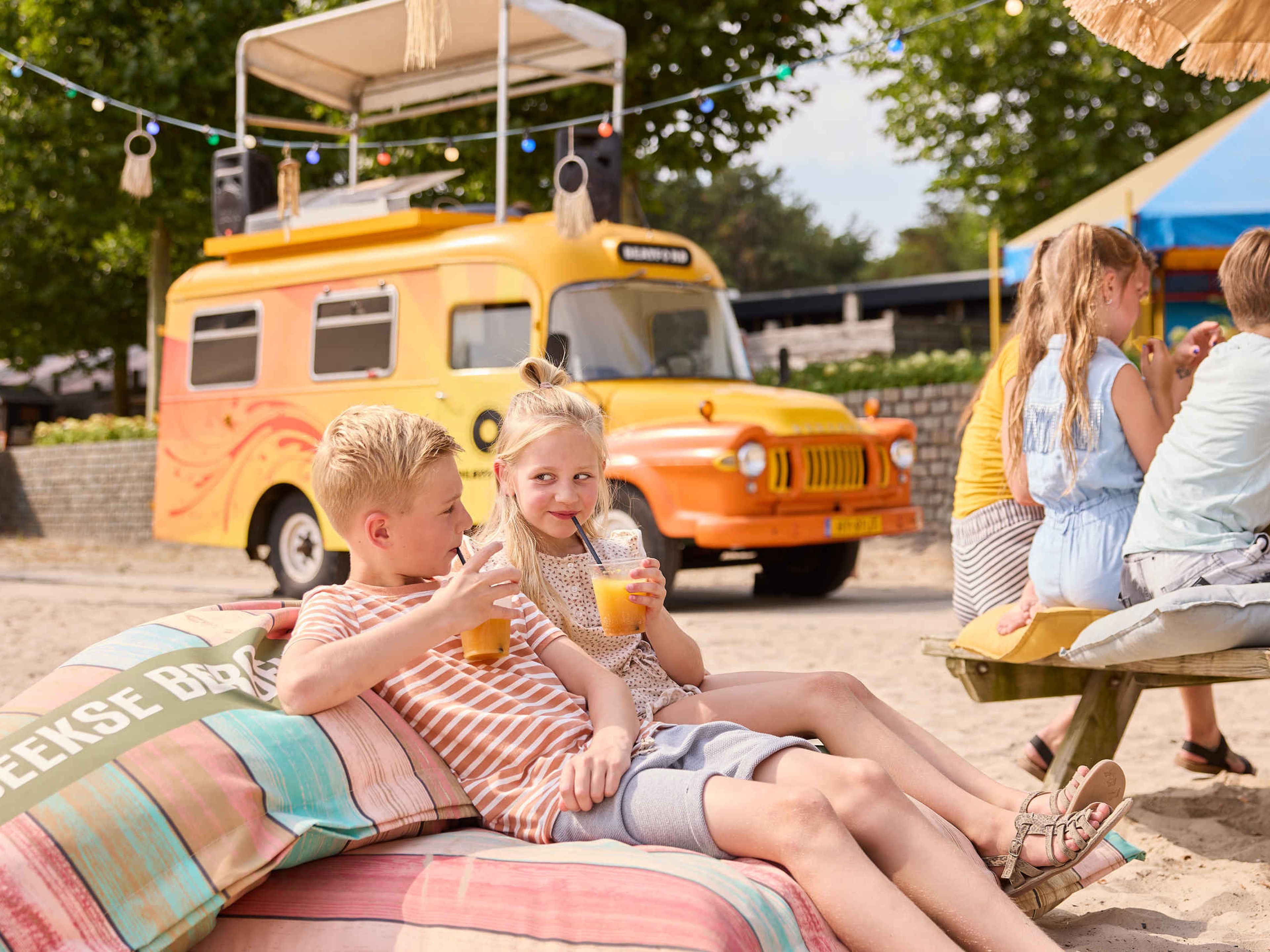 Zomer kinderen drinken iets bij de beachbar in Speelland Beekse Bergen