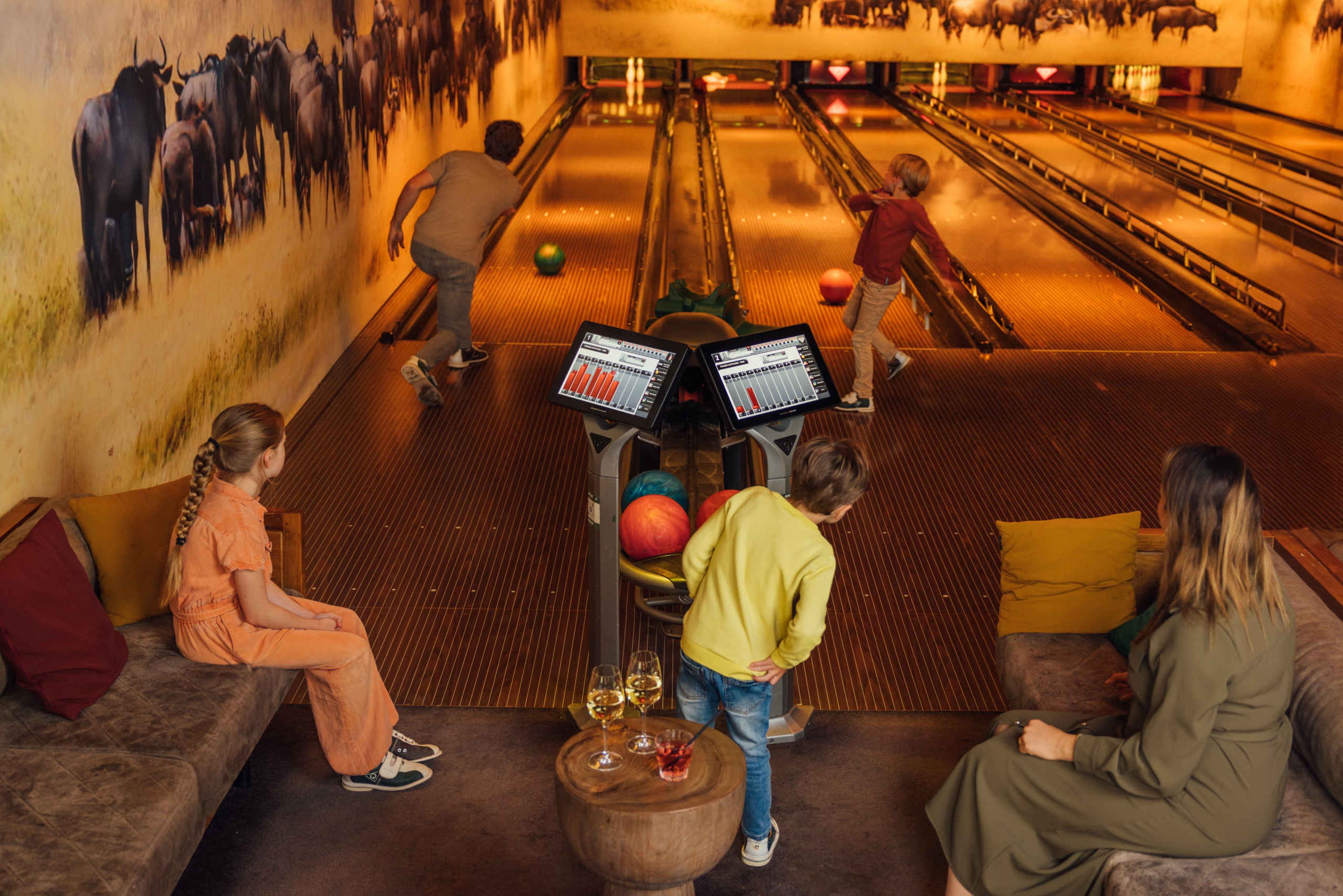 Gezin aan het bowlen in Pamoja Lounge Karibu Town op Safari Resort Beekse Bergen
