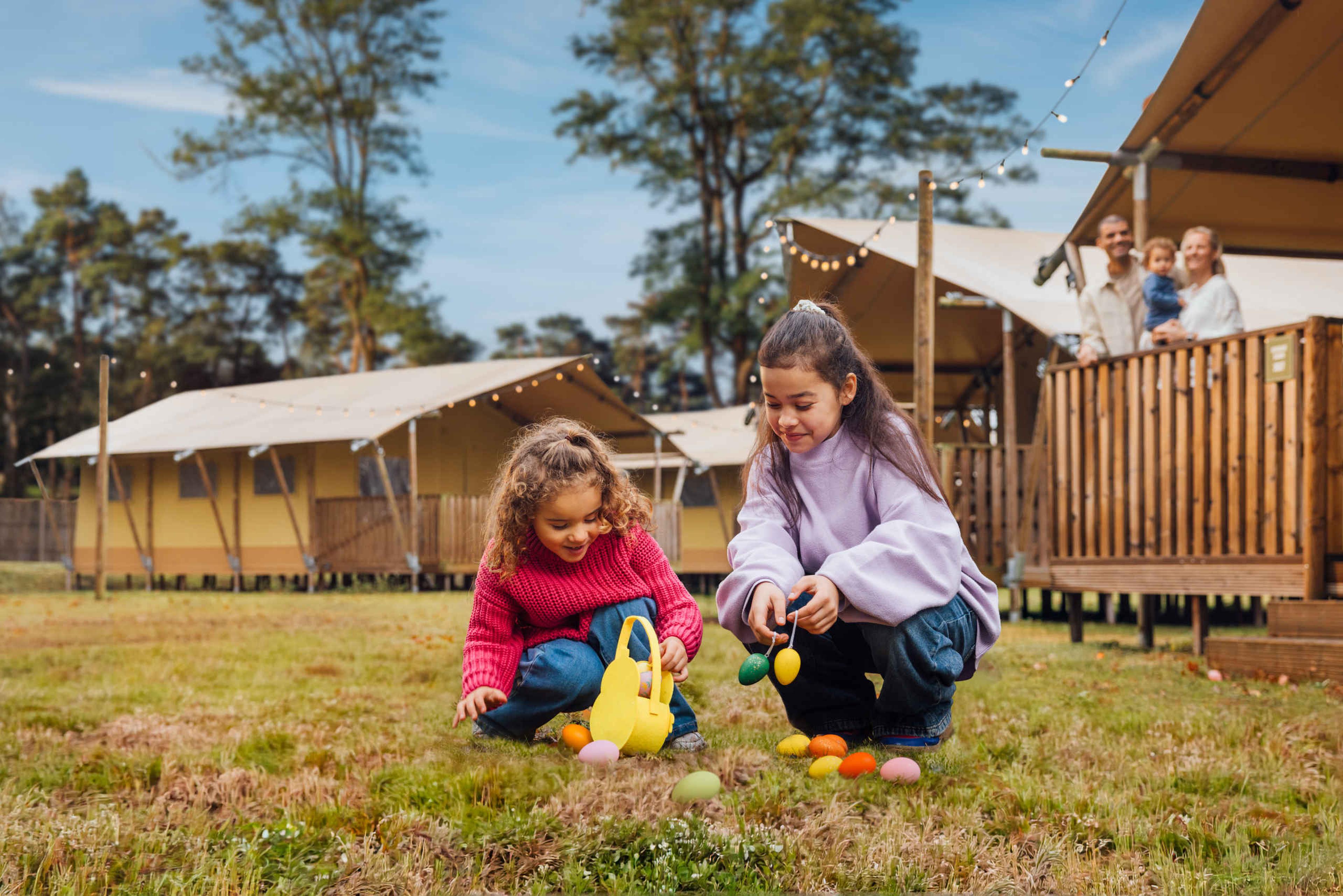 Twee kinderen zoeken paaseieren tijdens de paasvakantie op Lake Resort Beekse Bergen.