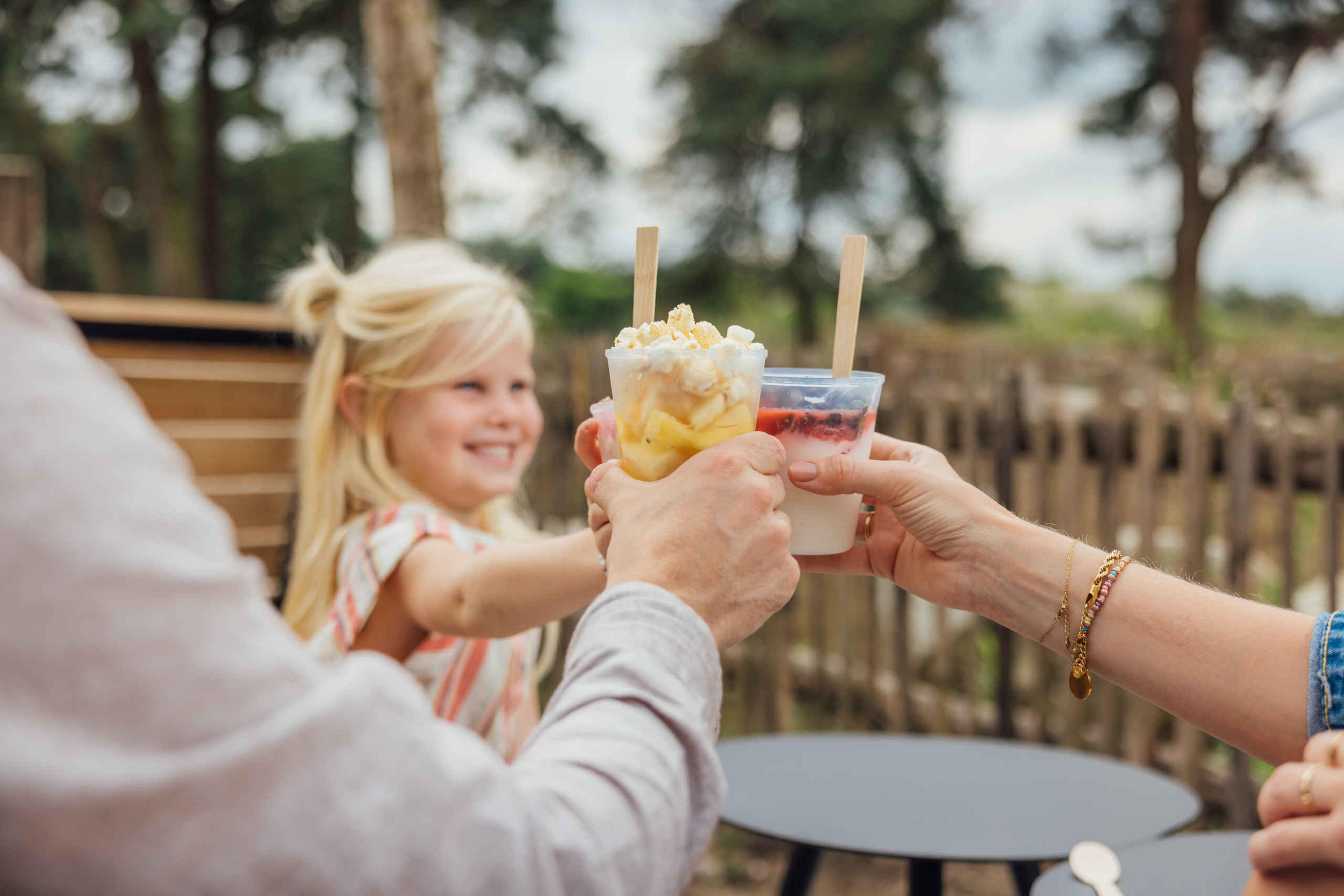 Terras met meisje die een fruitbeker heeft in restaurant Mugunda Safaripark Beekse Bergen