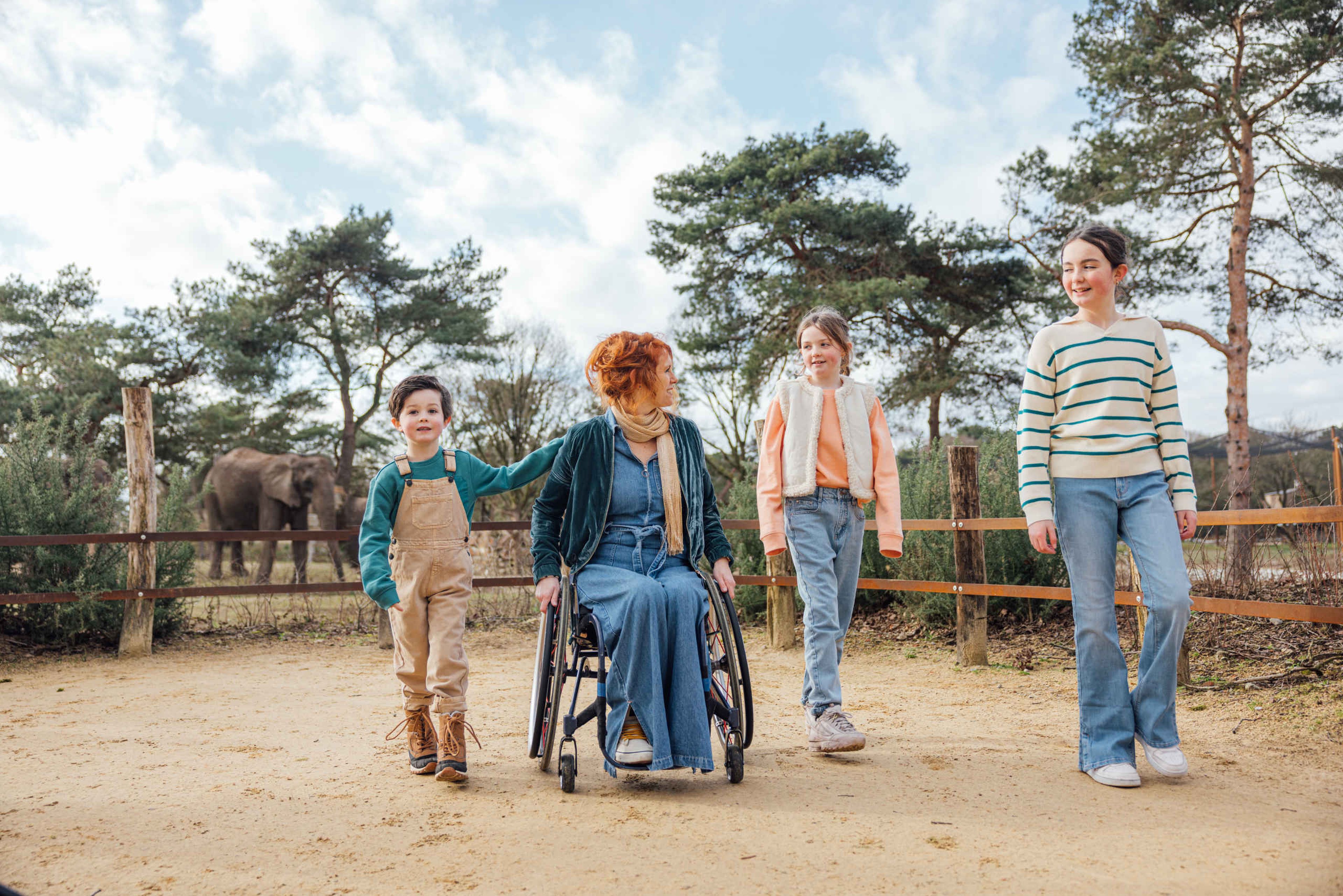 Kinderen en gezin bij olifant moeder in rolstoel Safaripark Beekse Bergen
