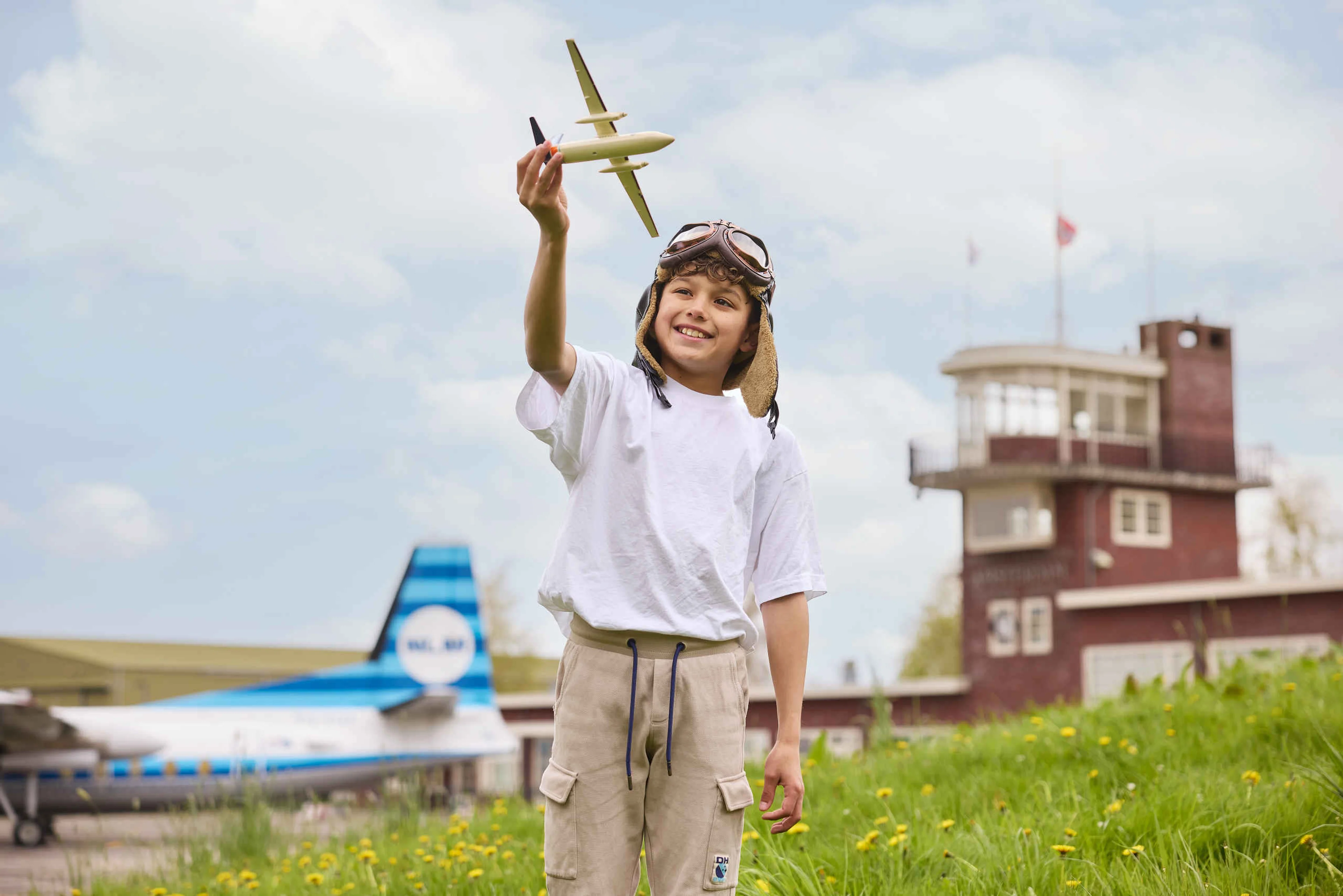 Jongen met modelvliegtuig kind met pilotenmuts Luchtvaartmuseum Aviodrome