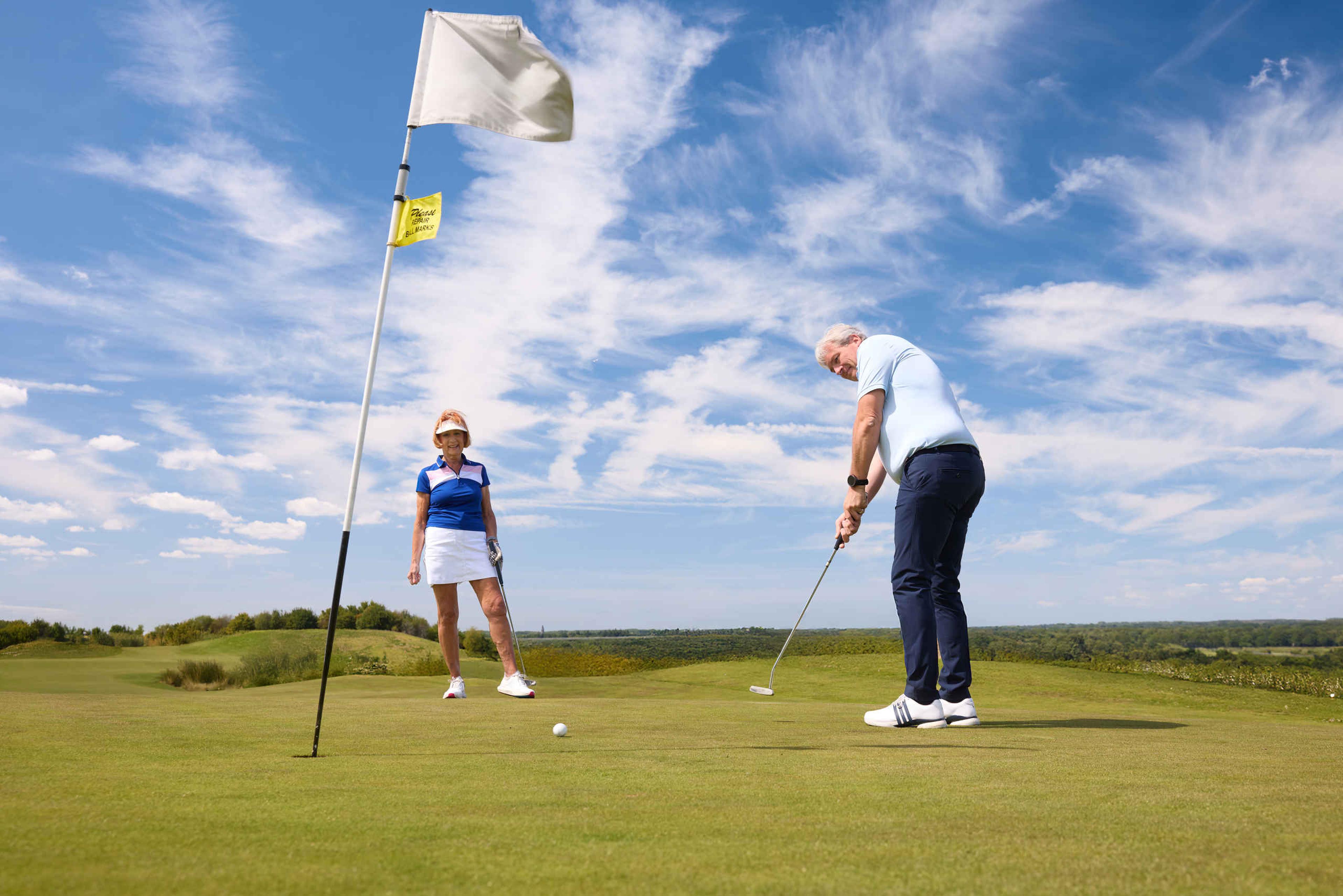 Een man putt zijn golfbal op de green van hole 2 van de sprookjesbaan bij Golf De Gulbergen