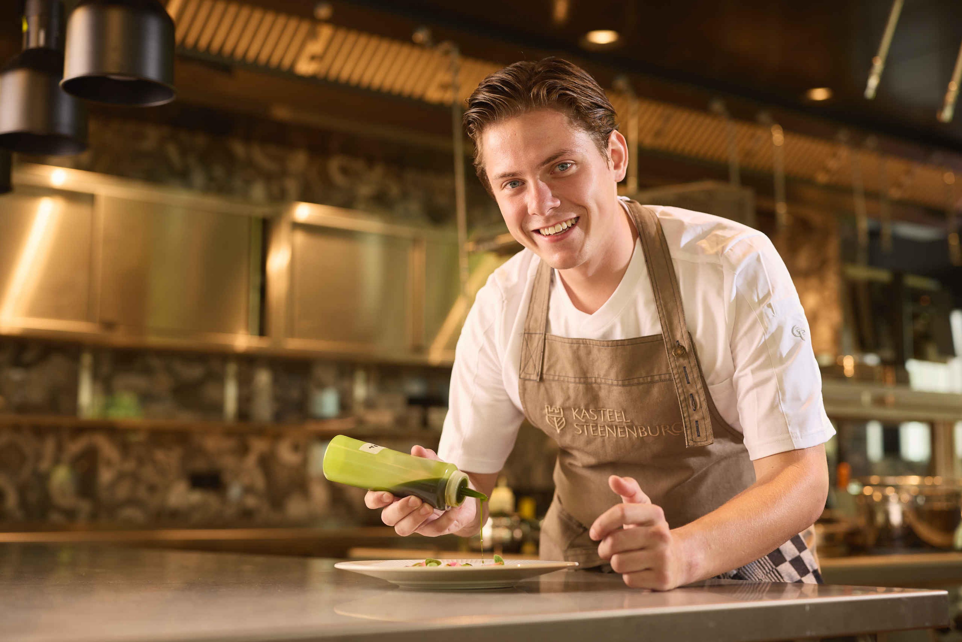 Een medewerker in de keuken van Kasteel Steenenburg