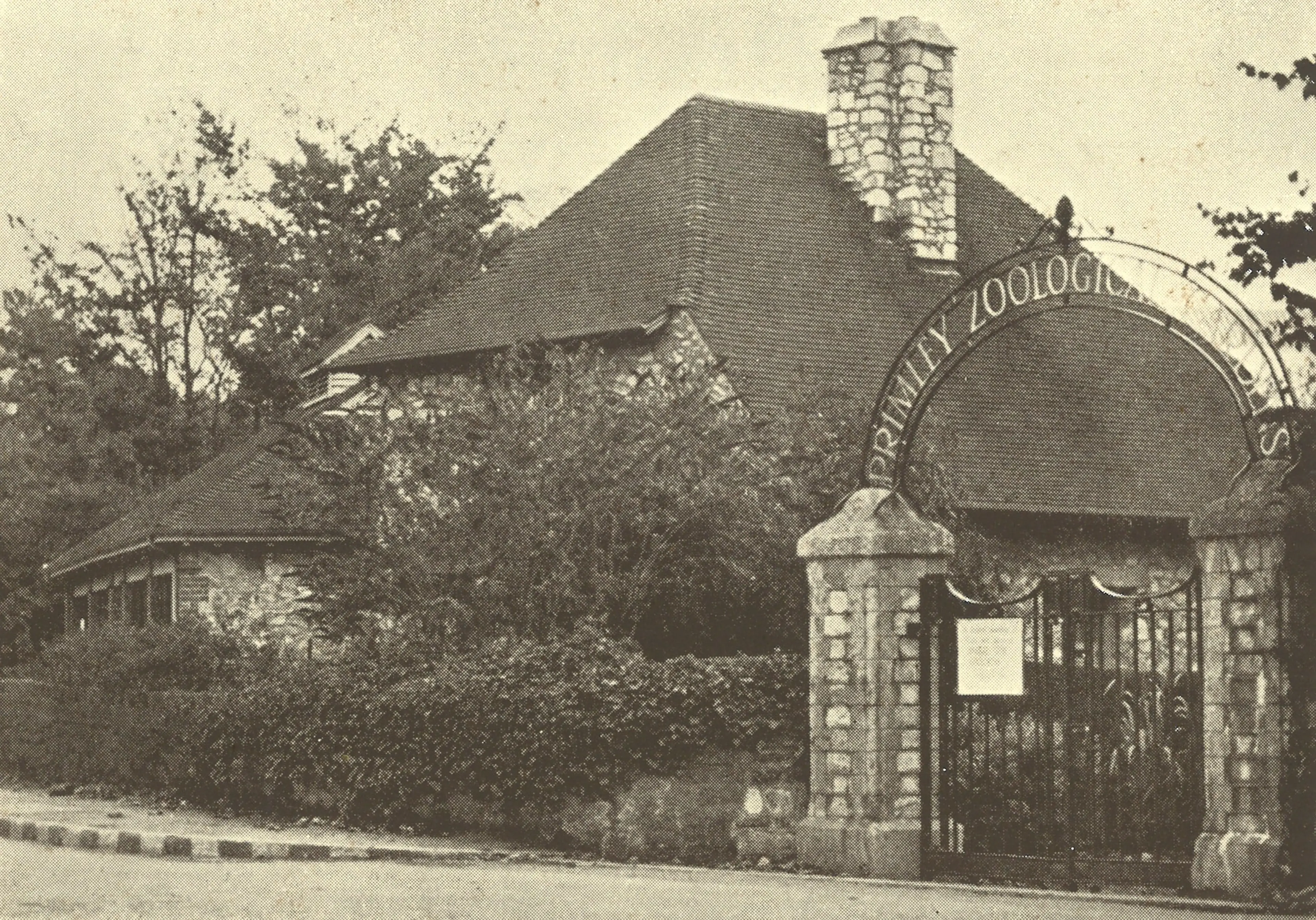 The original entrance to Paignton Zoo as it looked in 1941 with cast iron arch reading 'Primley Zoological Gardens' in black and white